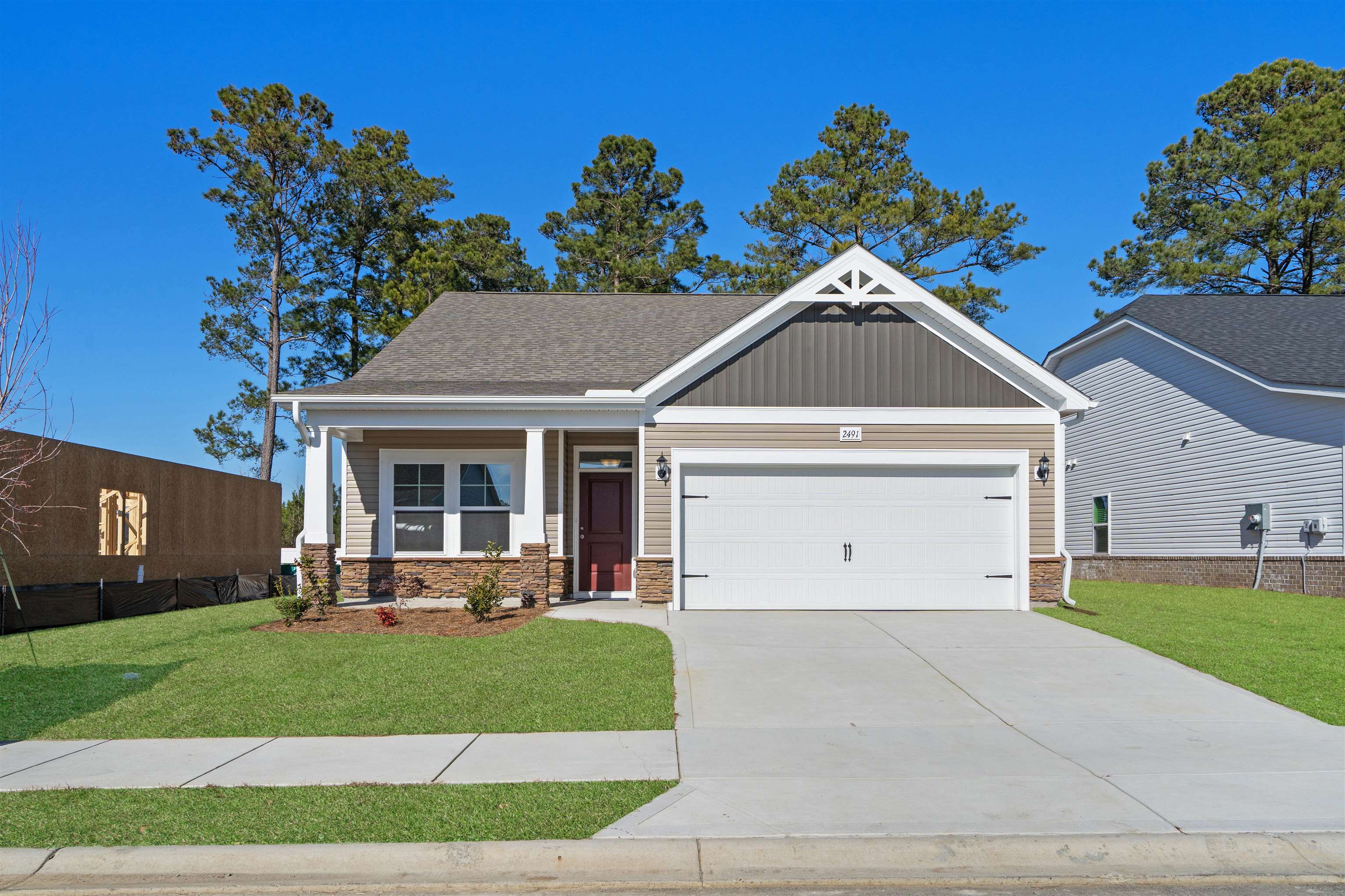 2491 Campton Loop Conway, SC 29527 - Photo 34 of 38 Craftsman house with a porch, concrete driveway, a garage, stone siding, and board and batten siding