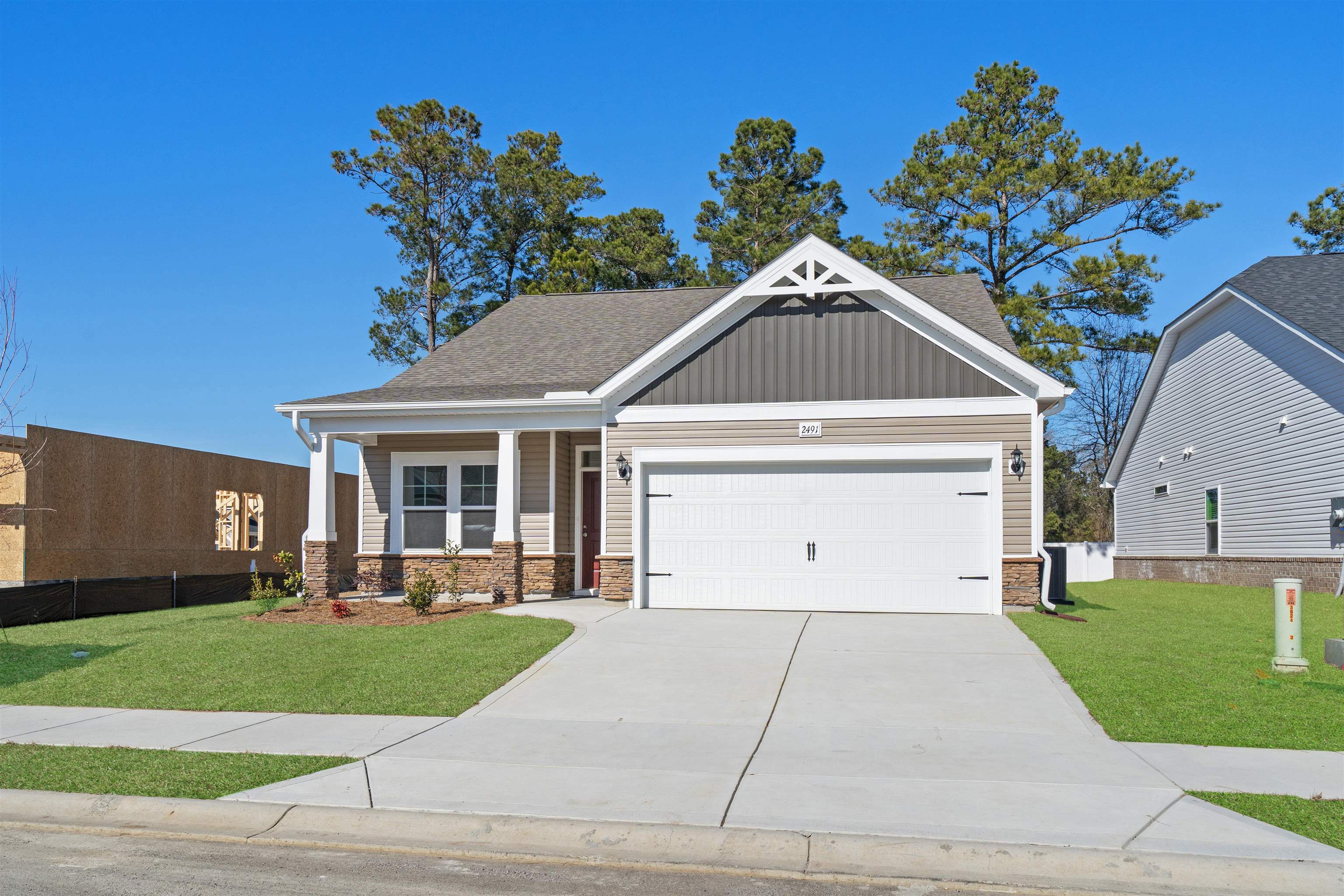2491 Campton Loop Conway, SC 29527 - Photo 35 of 38 Craftsman house featuring a porch, concrete driveway, a garage, board and batten siding, and roof with shingles