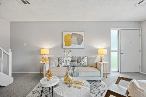 a living room with furniture and a lamp