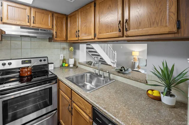 a kitchen with a sink a stove and cabinets