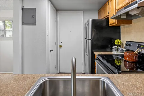 a kitchen with stainless steel appliances granite countertop a refrigerator