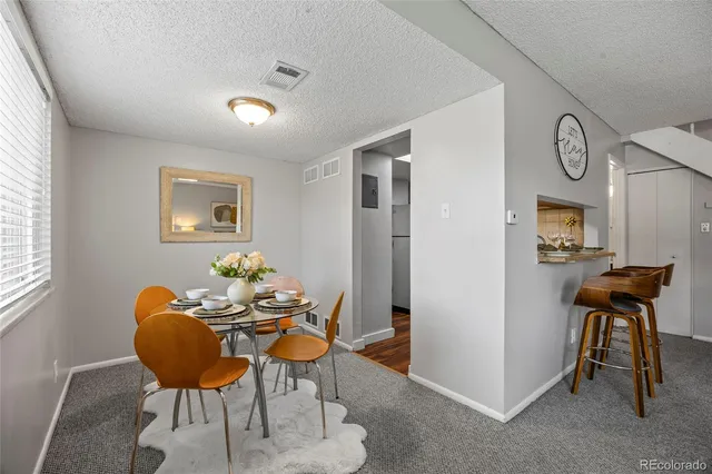 a dining room with furniture and window