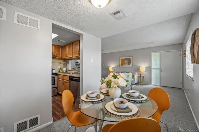 a dining room with furniture and chandelier