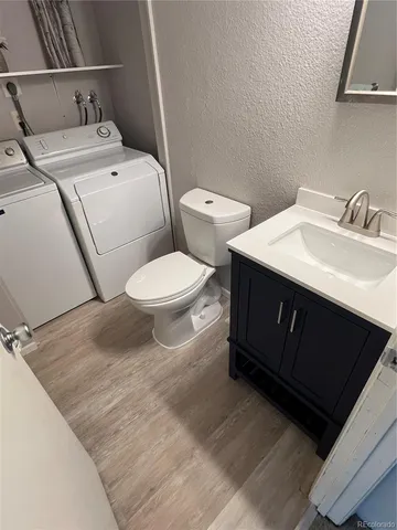 a white toilet sitting next to a bathroom sink