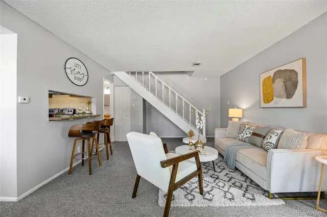 a living room with furniture a clock and a window