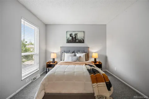 a bed sitting in a bedroom next to a window