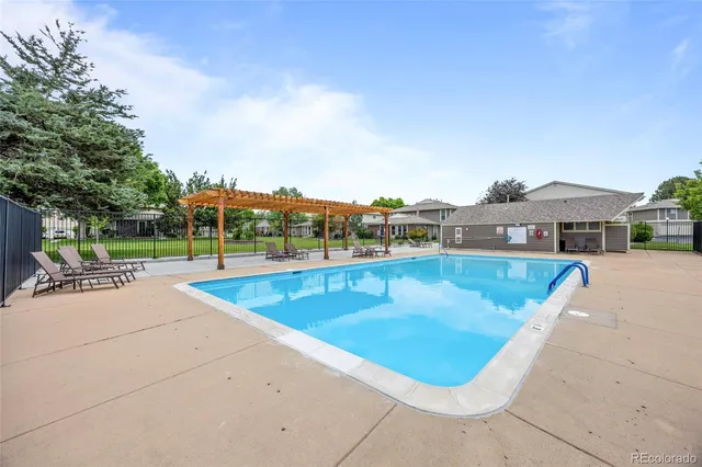 a view of a swimming pool with a lawn chairs