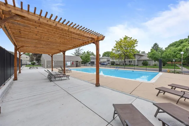 a view of a terrace with chairs and bench