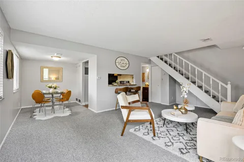 a living room with furniture and a clock