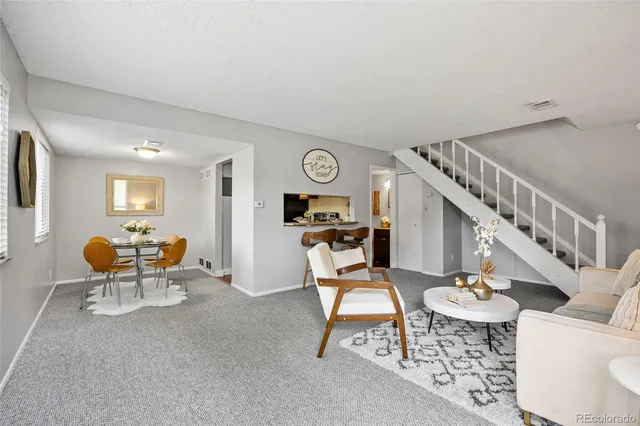 a living room with furniture and a clock
