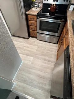 a kitchen with granite countertop a stove and a microwave