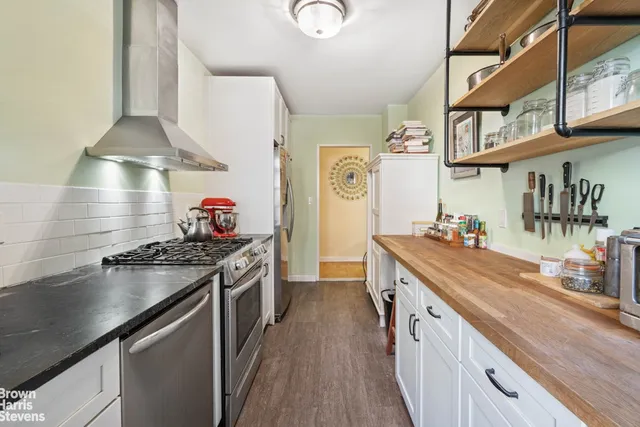 a kitchen with stainless steel appliances granite countertop a stove and a sink