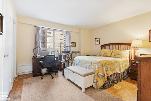 a bedroom with a bed chair and a window