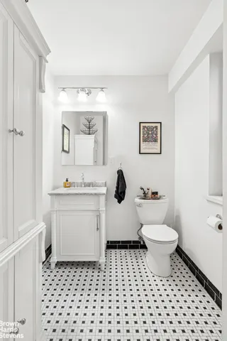 a bathroom with a sink toilet a mirror and vanity