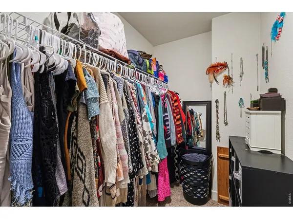 a view of walk in closet with clothes