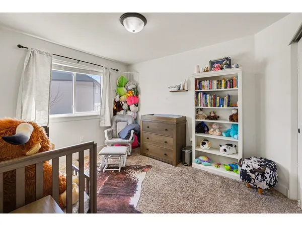 a living room with furniture and a book shelf
