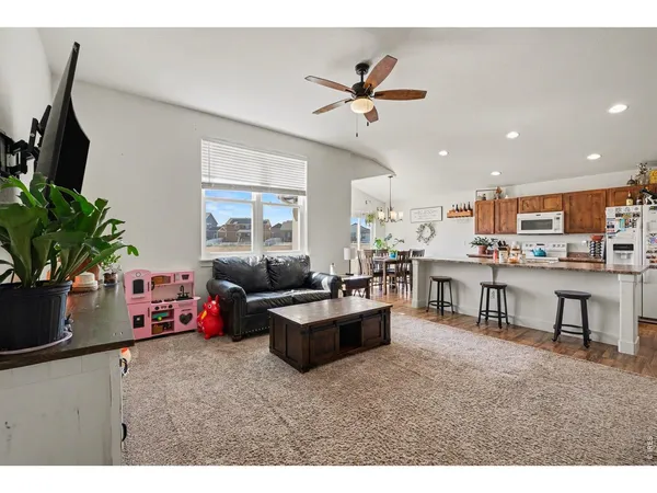 a living room with furniture and kitchen view