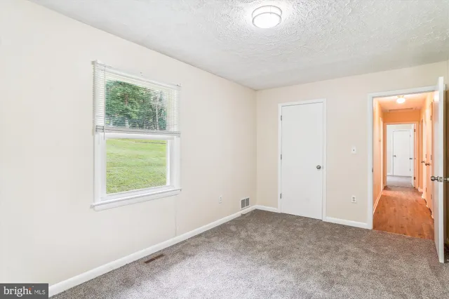 a view of a livingroom with furniture and a chair