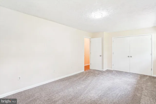 a bedroom with a bed and a lamp