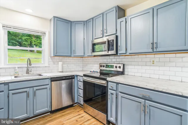 a kitchen with a sink stove and cabinets