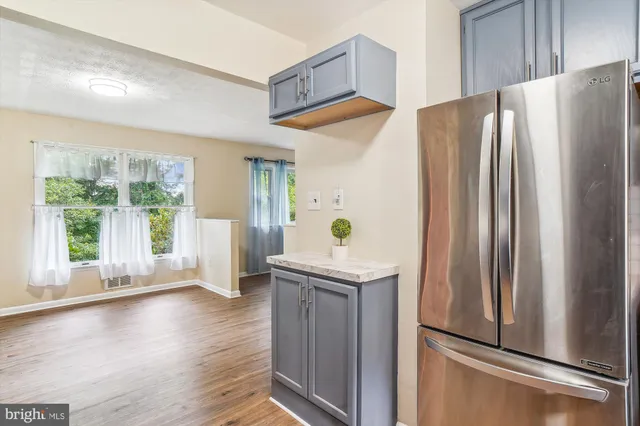 a kitchen with stainless steel appliances a refrigerator and a window
