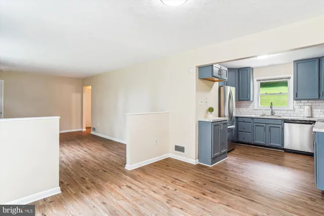 a kitchen with stainless steel appliances a refrigerator and a stove top oven
