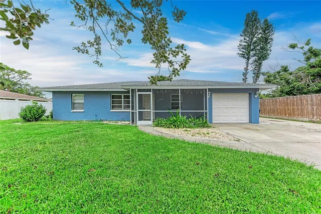 a front view of a house with a garden and yard