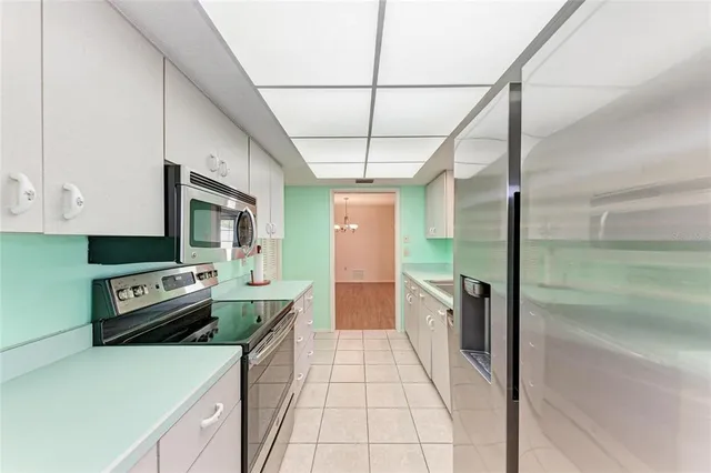 a kitchen with a stove a refrigerator and a sink