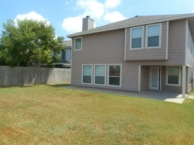a view of a house with a yard and a garage