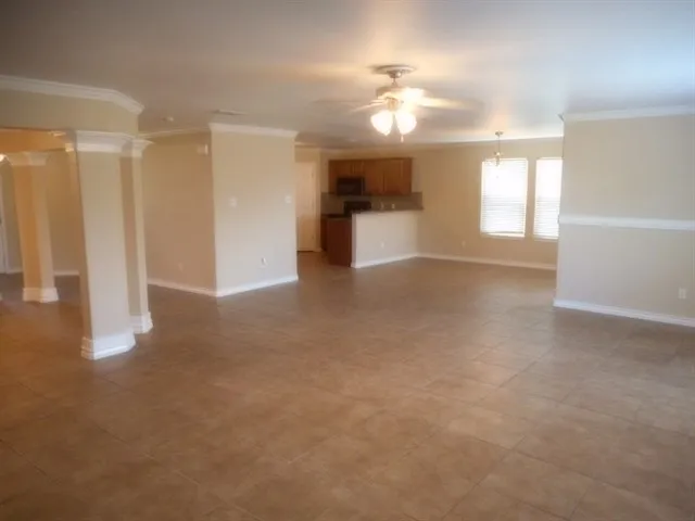 a view of a big room with windows and chandelier