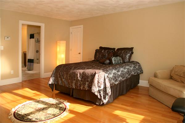 115 A Lakeshore Road Boxford, MA 01921 - Photo 19 of 29 a large bed sitting in a bedroom next to a window and a bedroom