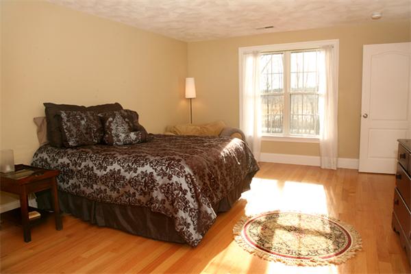 115 A Lakeshore Road Boxford, MA 01921 - Photo 20 of 29 a bed sitting in a bedroom next to a window
