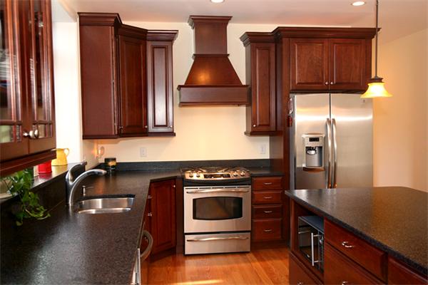 115 A Lakeshore Road Boxford, MA 01921 - Photo 3 of 29 a kitchen with wooden cabinets and a stove top oven
