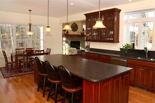 115 A Lakeshore Road Boxford, MA 01921 - Photo 4 of 29 a kitchen with a kitchen island a stove a table a sink and cabinets