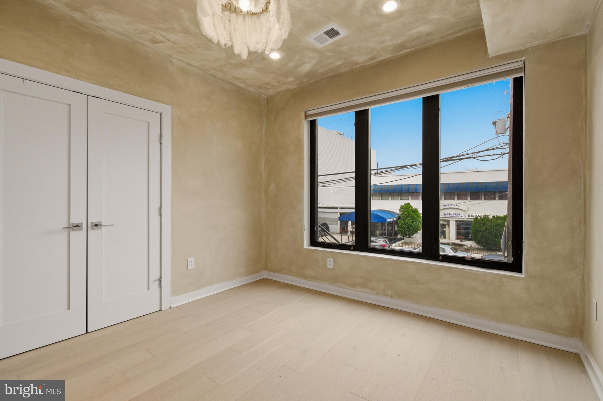 531 Kennedy Street Northwest, Unit 3 Washington, DC 20011 - Photo 16 of 19 a view of a big room with windows and chandelier