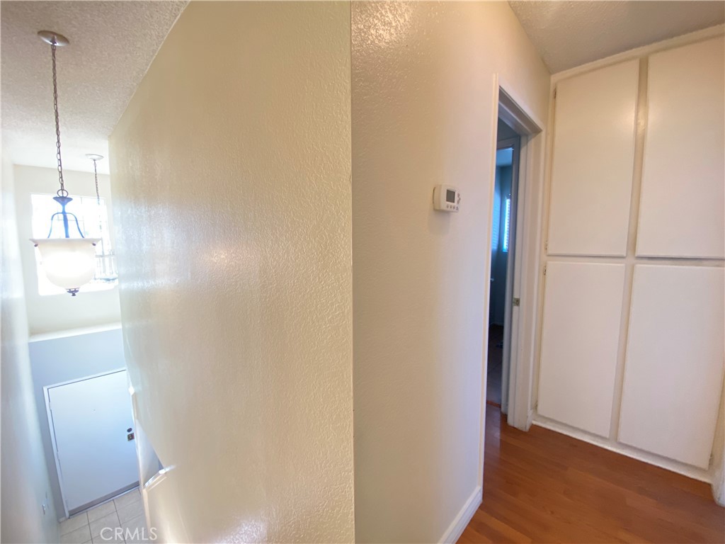 156 West Walnut Avenue, Unit A Rialto, CA 92376 - Photo 11 of 28 a view of a hallway with wooden floor