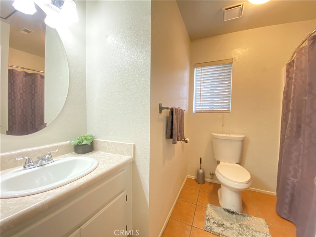 156 West Walnut Avenue, Unit A Rialto, CA 92376 - Photo 13 of 28 a bathroom with a sink and a toilet