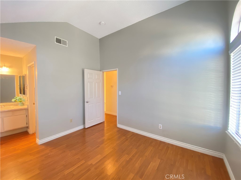 156 West Walnut Avenue, Unit A Rialto, CA 92376 - Photo 19 of 28 a view of an empty room with wooden floor and a window