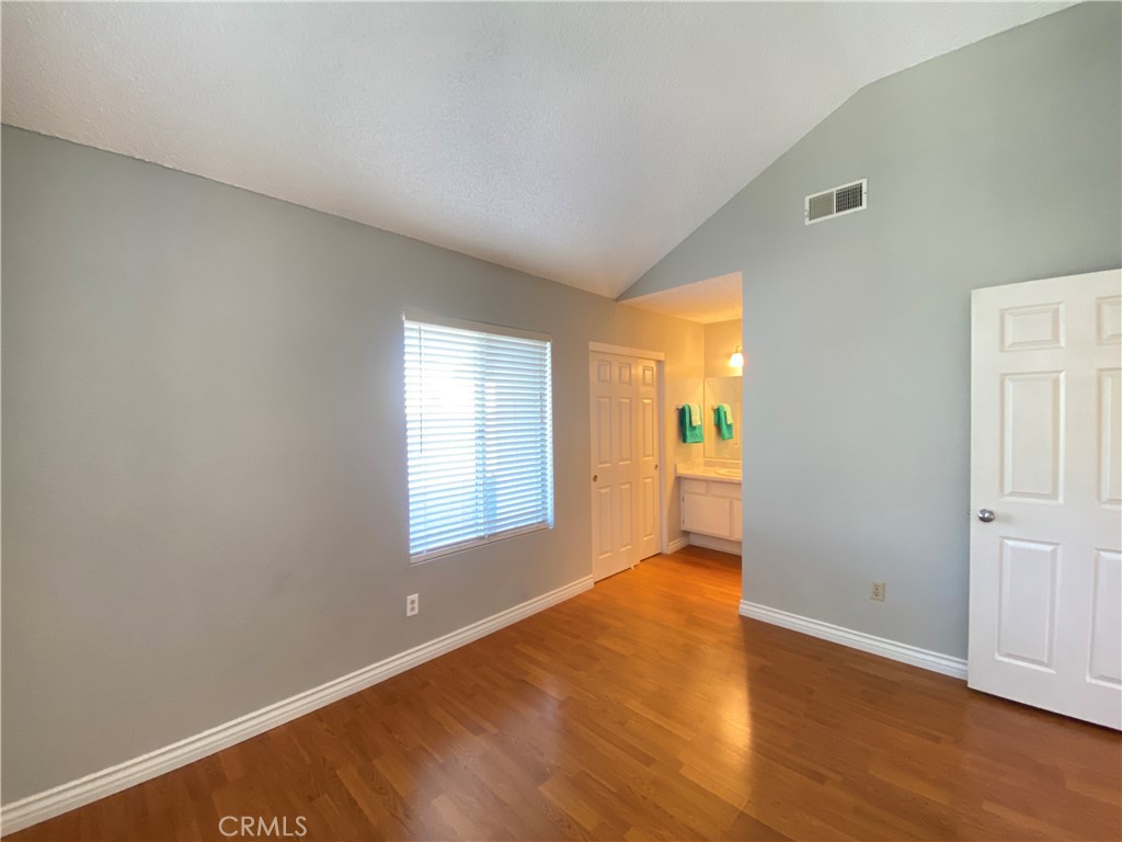 156 West Walnut Avenue, Unit A Rialto, CA 92376 - Photo 20 of 28 a view of an empty room with wooden floor and a window