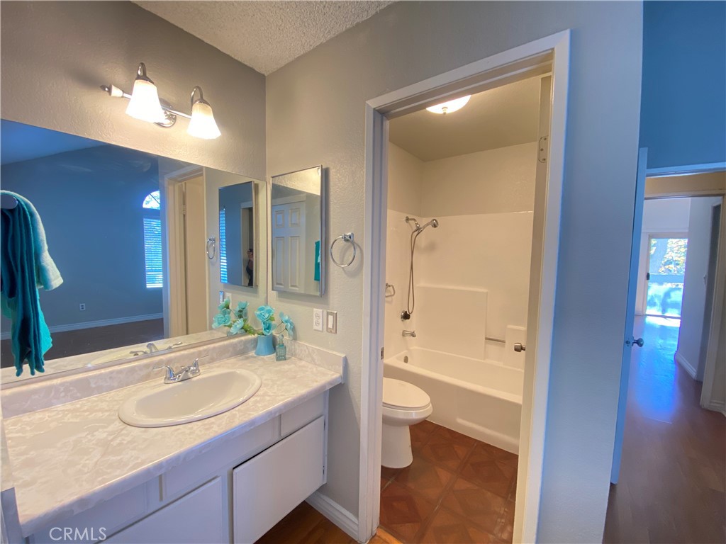 156 West Walnut Avenue, Unit A Rialto, CA 92376 - Photo 21 of 28 a bathroom with a sink a toilet and shower