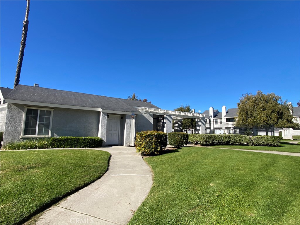 156 West Walnut Avenue, Unit A Rialto, CA 92376 - Photo 25 of 28 a front view of a house with a yard and garage