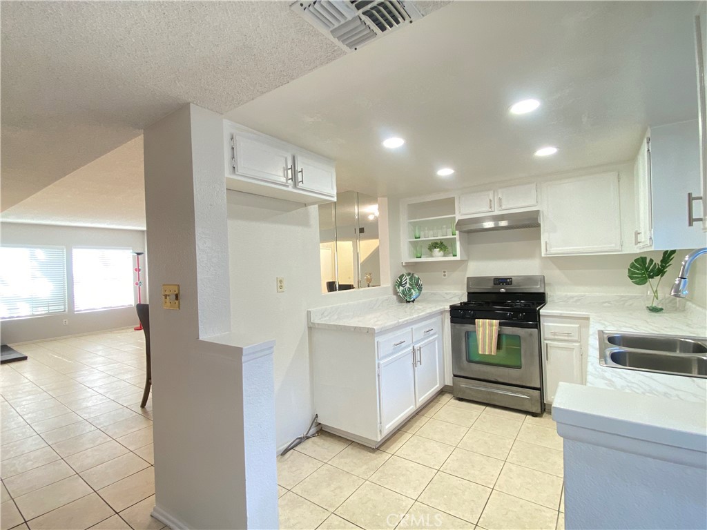 156 West Walnut Avenue, Unit A Rialto, CA 92376 - Photo 6 of 28 a open kitchen with stainless steel appliances granite countertop a stove and a sink