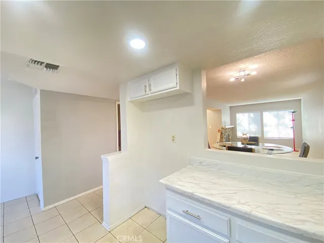 a view of an empty room with window and a ceiling fan