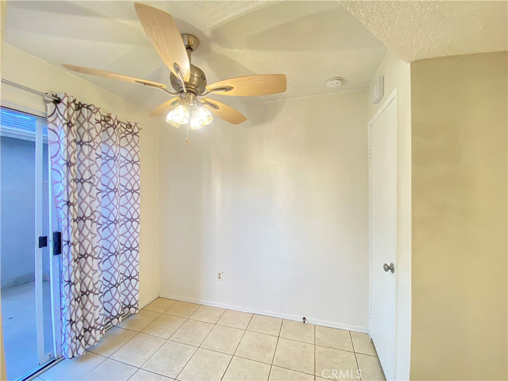 156 West Walnut Avenue, Unit A Rialto, CA 92376 - Photo 9 of 28 a view of an empty room with window and a ceiling fan