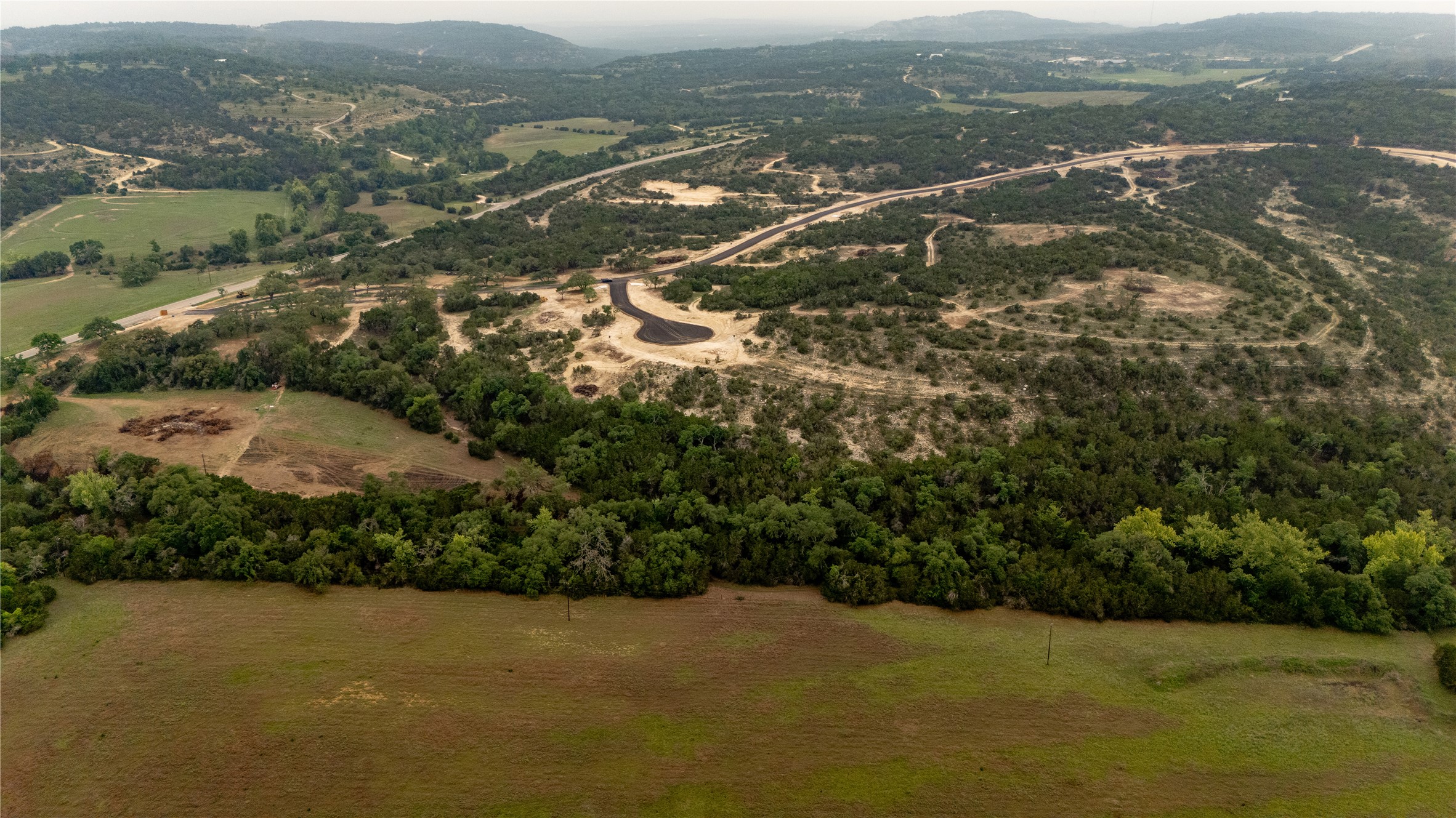 Lot 25 Ranch Road 165 Dripping Springs, TX 78620 - Photo 3 of 8 Expansive rural landscape featuring a mix of mature tree coverage, open fields, and undeveloped land