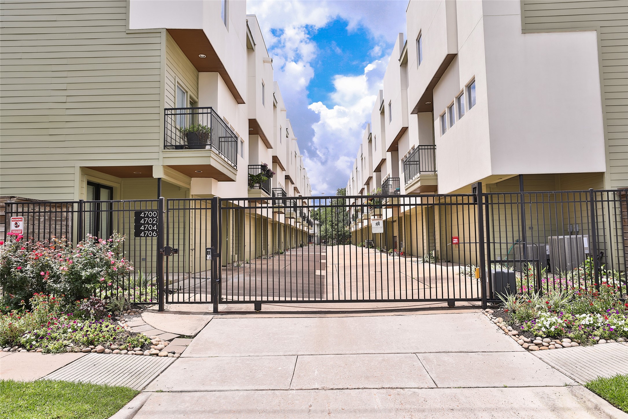 a view of a house with a small yard and wooden floor and fence