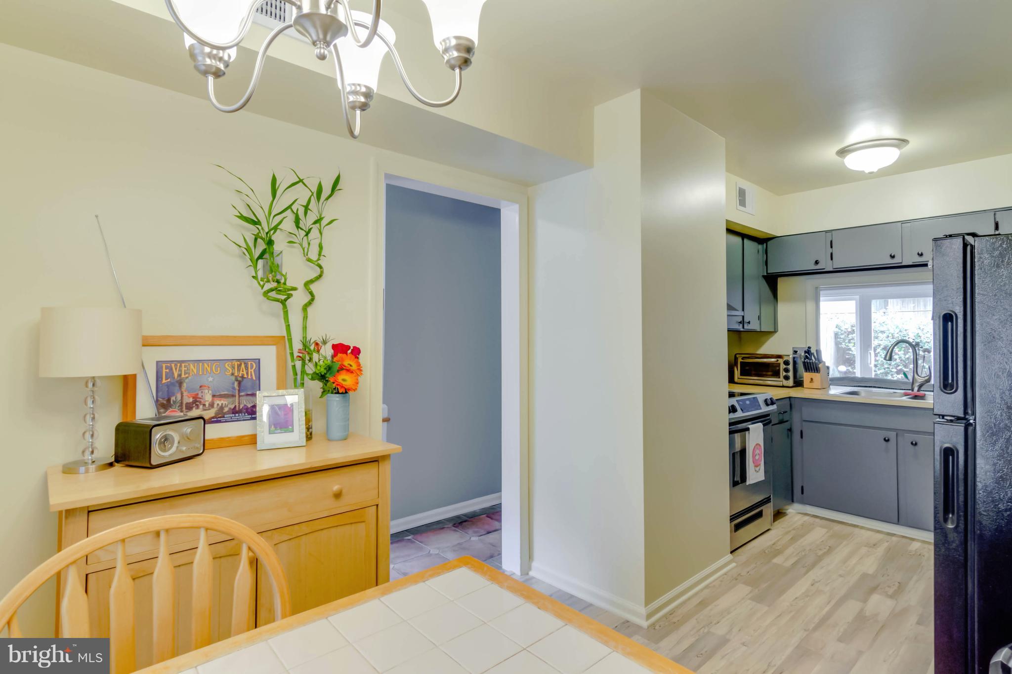 8317 Kingsgate Road, Unit 517 Springfield, VA 22152 - Photo 12 of 30 a kitchen with kitchen island granite countertop cabinets stainless steel appliances a sink and a counter top space
