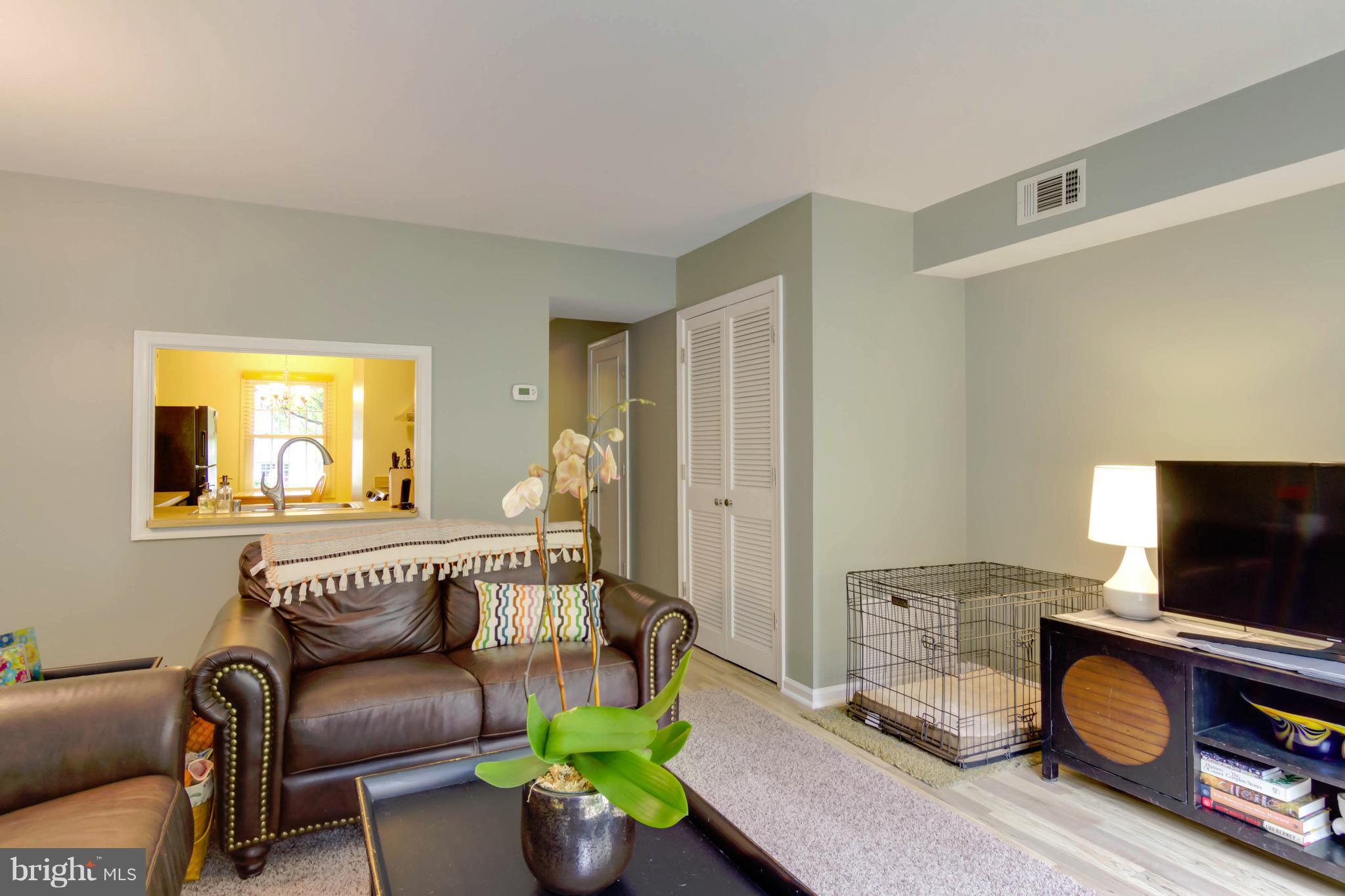 8317 Kingsgate Road, Unit 517 Springfield, VA 22152 - Photo 7 of 30 a living room with furniture and a flat screen tv