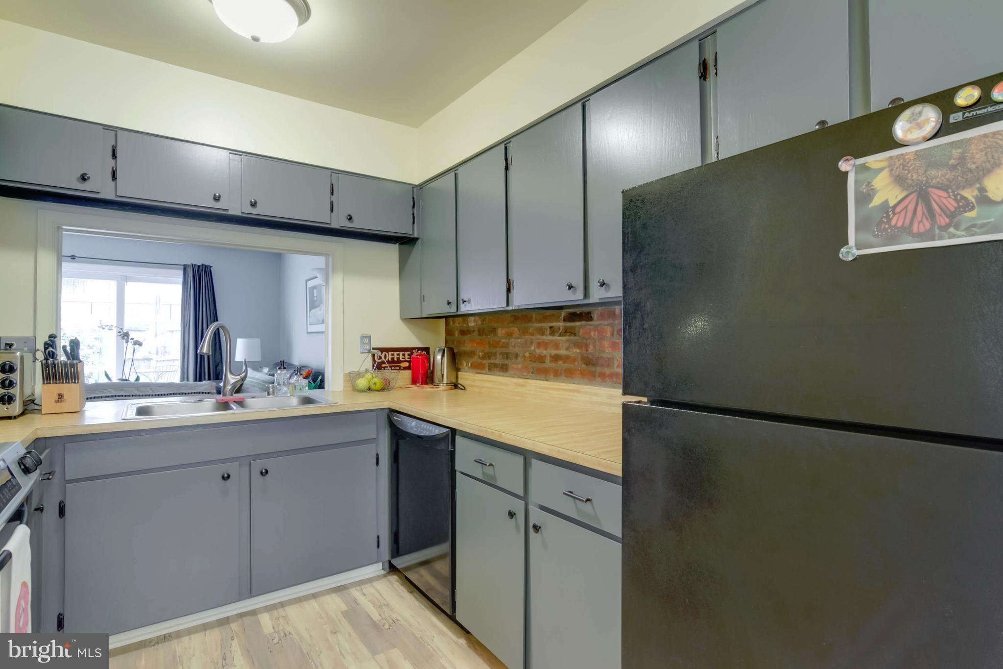 8317 Kingsgate Road, Unit 517 Springfield, VA 22152 - Photo 8 of 30 a kitchen with cabinets and white appliances