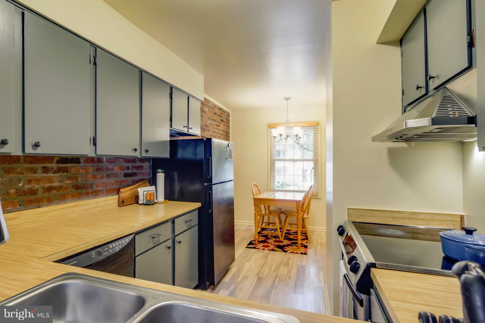8317 Kingsgate Road, Unit 517 Springfield, VA 22152 - Photo 10 of 30 a kitchen with a sink appliances and cabinets